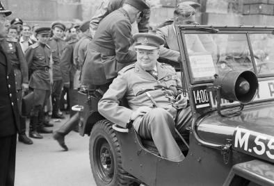 winston_churchill_in_a_jeep_outside_the_german_reichstag_during_a_tour_of_the_ruined_city_of_berlin_16_july_1945-_bu8950